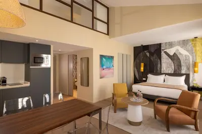 a hotel room with a bed and a kitchen at Palais Ségurane Boutique Hôtel in Nice