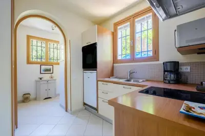 a kitchen with a sink and a counter top at Studio charmant à Cagnes-sur-Mer de 35 m² + piscine privée in Cagnes-sur-Mer