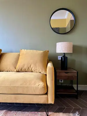 a couch in a living room with a table and a mirror at Appartement moderne avec une belle vue in Nice
