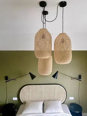 a bedroom with three lights hanging over a bed at Appartement moderne avec une belle vue in Nice