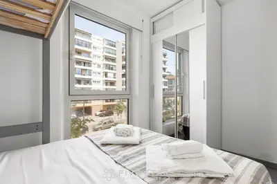 a bedroom with a bed with two towels on it at Loft Le Galet FSHH in Nice