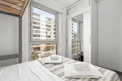 a bedroom with a bed and a large window at Loft Le Galet FSHH in Nice