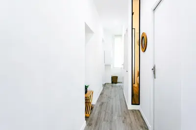 a hallway with white walls and a wooden floor at L26 Old Town central 5mins walk to Sea front AC WIFI in Nice