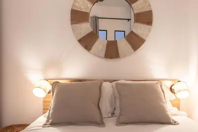 a bedroom with a mirror above a bed with pillows at L26 Old Town central 5mins walk to Sea front AC WIFI in Nice