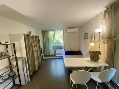 a room with a bed and a table and chairs at Nice ouest-Cosy Studio, Clim Wifi in Nice