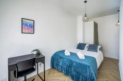a small bedroom with a bed and a desk at Maison Bianchi - Downtown Alsace Lorraine in Nice