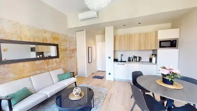 a living room with a couch and a table at ApartHotel Riviera - BALCON BARLA - Old Port PLace du Pin in Nice