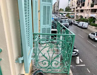 a balcony with a green railing on a building at ApartHotel Riviera - BALCON BARLA - Old Port PLace du Pin in Nice