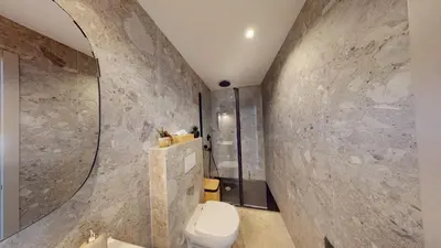 a bathroom with a toilet and a stone wall at ApartHotel Riviera - BALCON BARLA - Old Port PLace du Pin in Nice