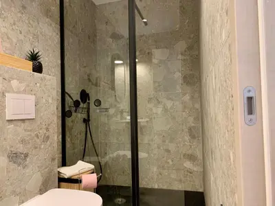 a bathroom with a glass shower with a toilet at ApartHotel Riviera - BALCON BARLA - Old Port PLace du Pin in Nice