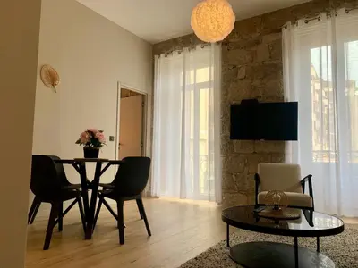 a living room with a dining room table and chairs at ApartHotel Riviera - BALCON BARLA - Old Port PLace du Pin in Nice