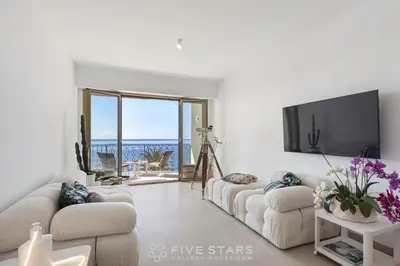 a living room with two couches and a flat screen tv at Suite Grand Sud FSHH in Nice