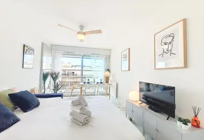a living room with a large white bed and a tv at Nestor&Jeeves - LIFESTYLE - Terrace - Modern in Nice