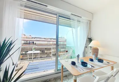 a dining room with a table and a large window at Nestor&Jeeves - LIFESTYLE - Terrace - Modern in Nice