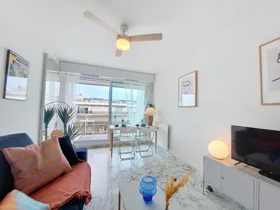 a living room with a couch and a tv and a table at Nestor&Jeeves - LIFESTYLE - Terrace - Modern in Nice