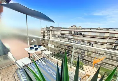 a balcony with a table and chairs and a large building at Nestor&Jeeves - LIFESTYLE - Terrace - Modern in Nice