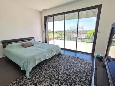a bedroom with a bed and a large window at Villa Les Oliviers by Interhome in Nice