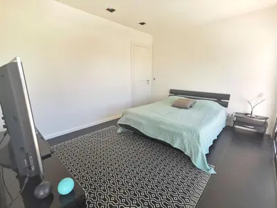 a bedroom with a bed and a flat screen tv at Villa Les Oliviers by Interhome in Nice