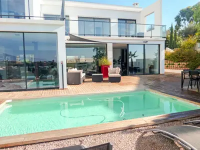 a swimming pool in front of a house at Villa Les Oliviers by Interhome in Nice
