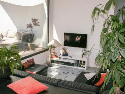 a living room with a couch and a tv at Villa Les Oliviers by Interhome in Nice