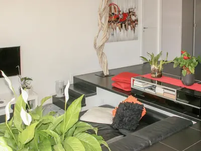 a living room with a couch and a table with plants at Villa Les Oliviers by Interhome in Nice