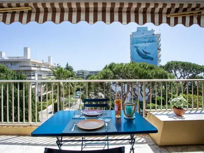 a blue table with a meal on a balcony at Studio le ponant by Interhome in Saint-Laurent-du-Var