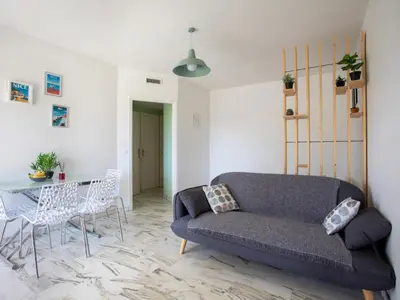 a living room with a couch and a table at Studio le ponant by Interhome in Saint-Laurent-du-Var