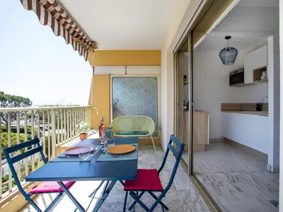 a blue table and chairs on a balcony at Studio le ponant by Interhome in Saint-Laurent-du-Var