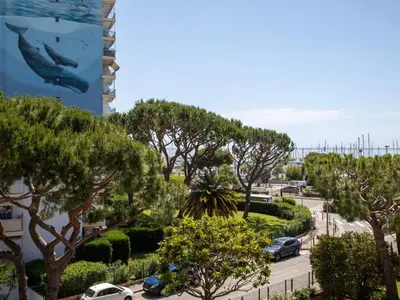 a view of a street with trees and cars at Studio le ponant by Interhome in Saint-Laurent-du-Var