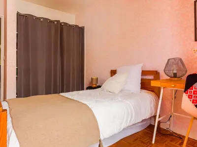 a bedroom with a bed and a table with a lamp at Apartment Les Balcons de Battisti by Interhome in Nice