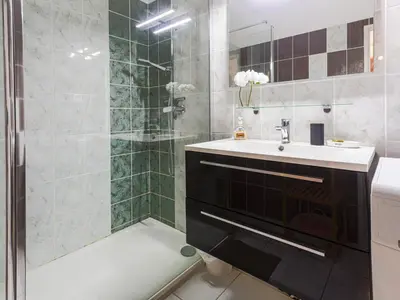 a bathroom with a shower and a sink and a tub at Apartment Les Balcons de Battisti by Interhome in Nice