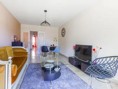 a living room with a couch and a tv at Apartment Les Balcons de Battisti by Interhome in Nice
