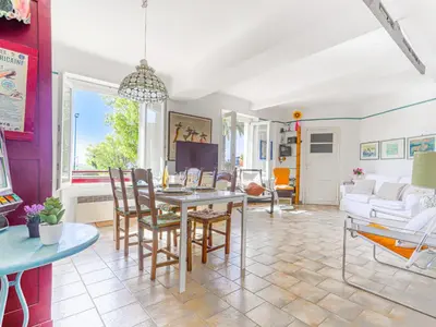 a living room with a table and chairs at Apartment Le Palais Foch by Interhome in Villefranche-sur-Mer