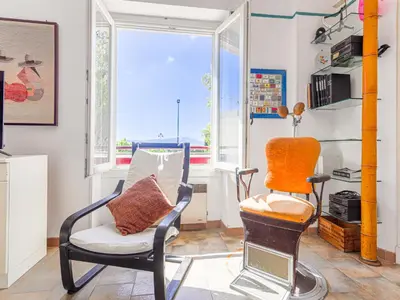 a living room with two chairs and a window at Apartment Le Palais Foch by Interhome in Villefranche-sur-Mer