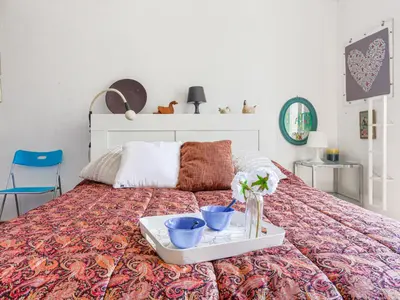 a bed with a tray with two blue bowls on it at Apartment Le Palais Foch by Interhome in Villefranche-sur-Mer