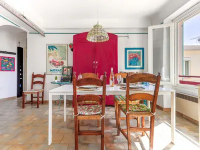a dining room with a white table and chairs at Apartment Le Palais Foch by Interhome in Villefranche-sur-Mer