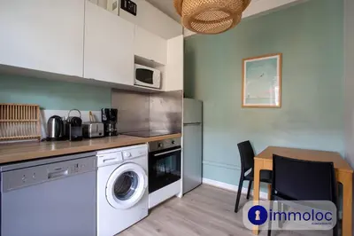a kitchen with a washing machine and a table at Apartment with 2 bedrooms Quartier Libération in Nice