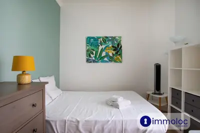 a small bedroom with a white bed and a lamp at Apartment with 2 bedrooms Quartier Libération in Nice