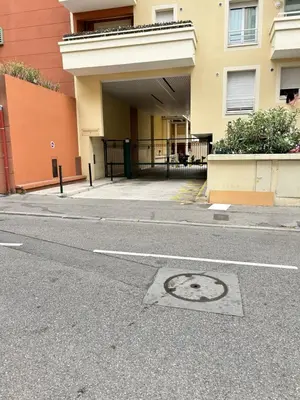 a street with a building and a manhole cover in the road at VUE mer 02 chambres 45M et parking in Nice