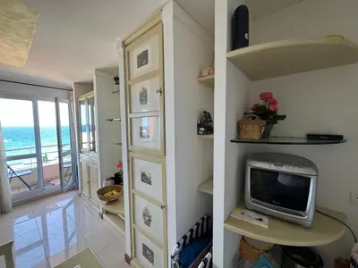 a living room with a tv and a room with the ocean at VUE mer 02 chambres 45M et parking in Nice