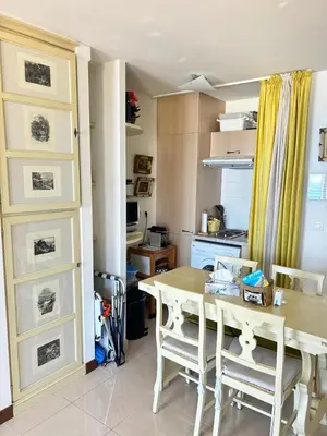 a kitchen with a table and chairs in a room at VUE mer 02 chambres 45M et parking in Nice