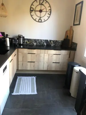 a kitchen with a large clock on the wall at Villa Nice in Nice