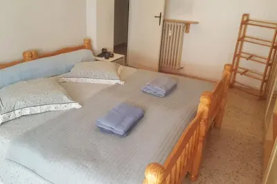 a large wooden bed with two pillows on it at F4 6 Couchages Terrasse Proche Centre in Nice