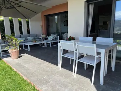 a white table and chairs on a patio at Joli 3 pièces ensoleillé sur les hauteurs de Nice in Nice