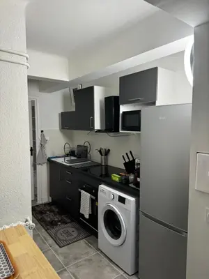 a kitchen with a refrigerator and a washing machine at Studio à Nice - 10 min de la plage in Nice