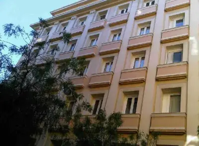 a tall pink building with many windows at 1 bedroom flat in the best street Nice in Nice