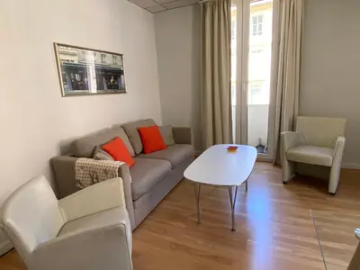 a living room with a couch and a table at 1 bedroom flat in the best street Nice in Nice