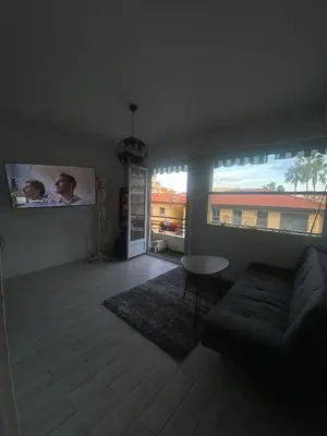 a living room with a couch and a large window at Nice apartment - Valrose - Cosy & Chill in Nice