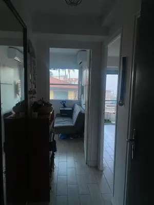 a hallway with a room with a couch and a window at Nice apartment - Valrose - Cosy & Chill in Nice