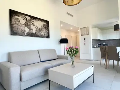 a living room with a couch and a table at Panoramic Sea View Appartment Blue Pearl in Nice